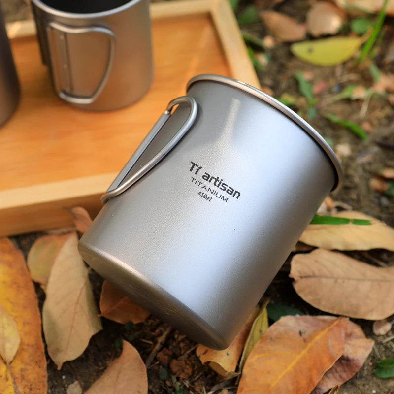 Titanium mug with 'Tiartisan' branding on a natural background
