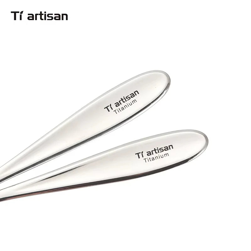 Two titanium utensils with 'Ti artisan' branding on a white background