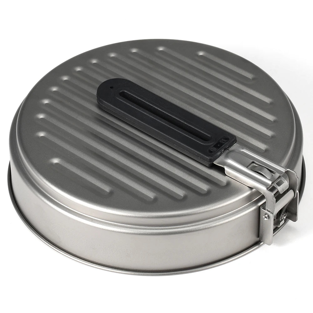Metallic round pan with black handle on a white background
