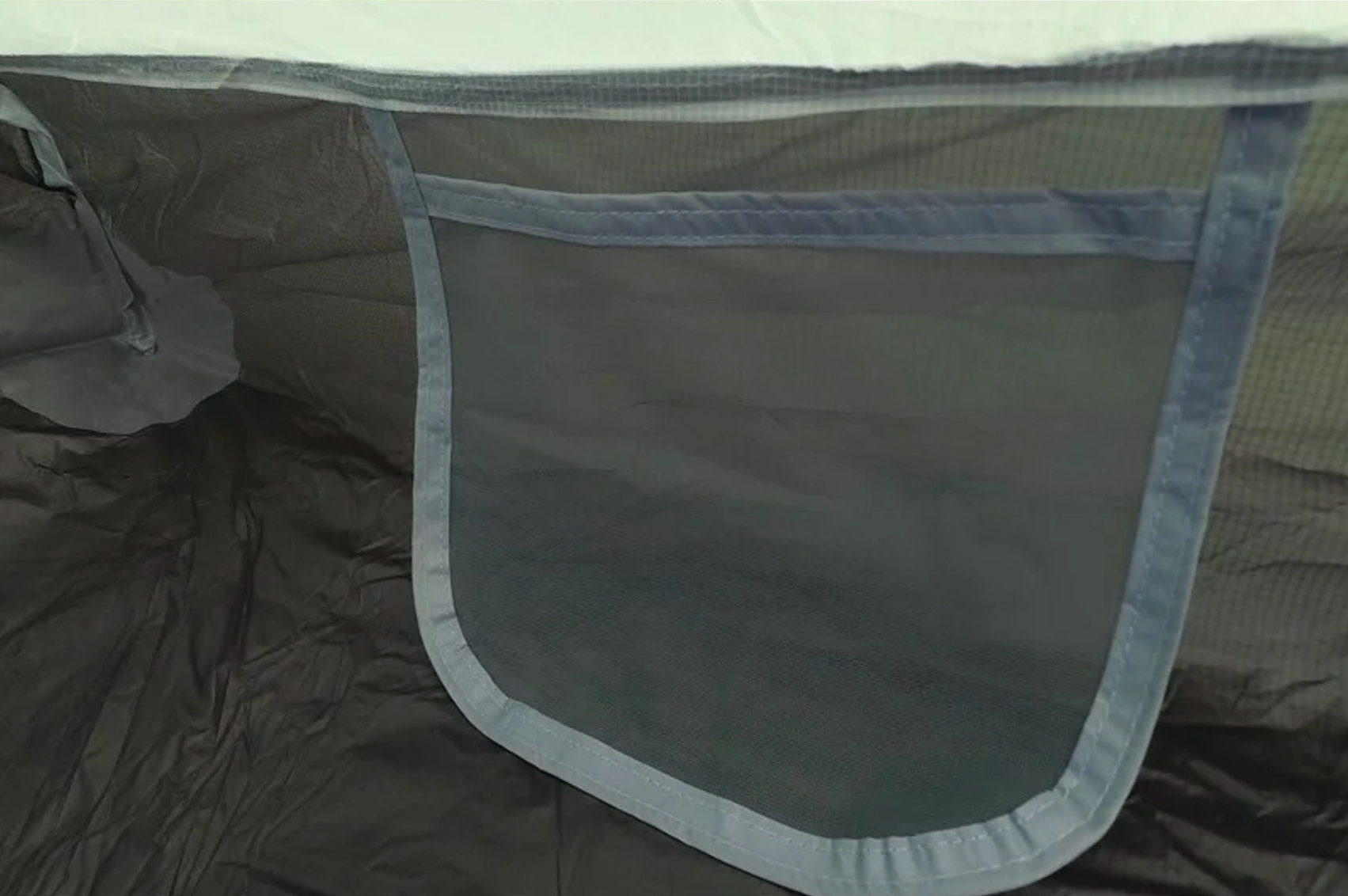 Dark gray fabric with mesh panel on a white background