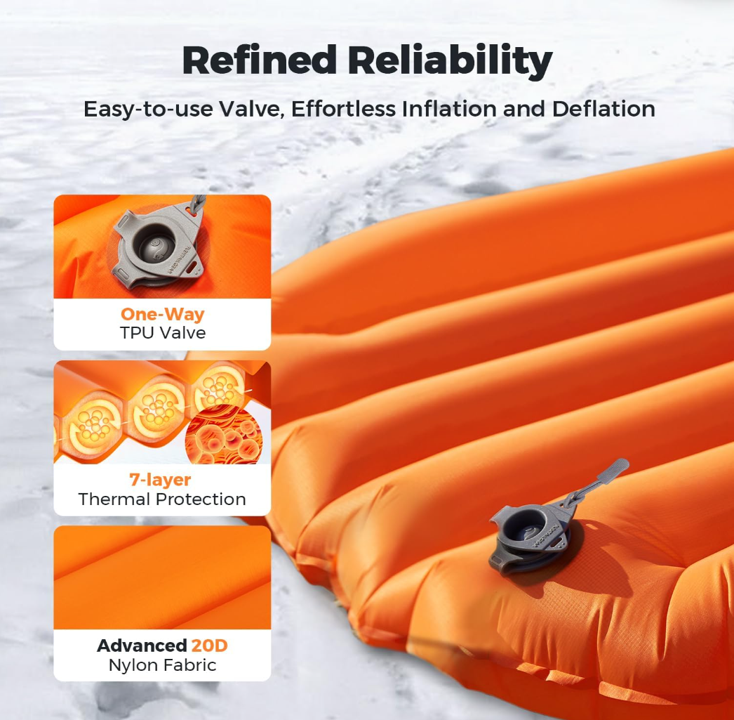 Orange inflatable mattress with valve features on a snowy background