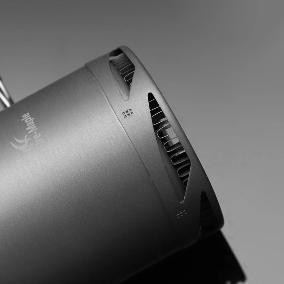 Close-up of a metallic device with a brand logo on a gray background