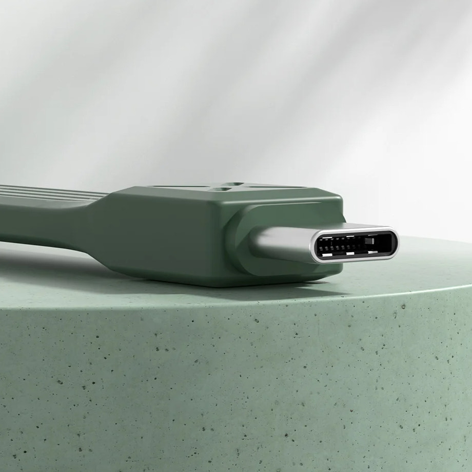 Green electronic device on a light green surface with a white background