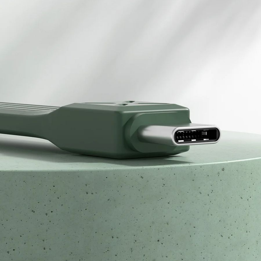 Green electronic device on a light green surface with a white background