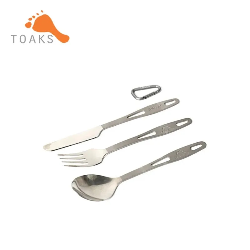 Set of camping utensils including a fork, spoon, and knife with a TOAKS logo on a white background.