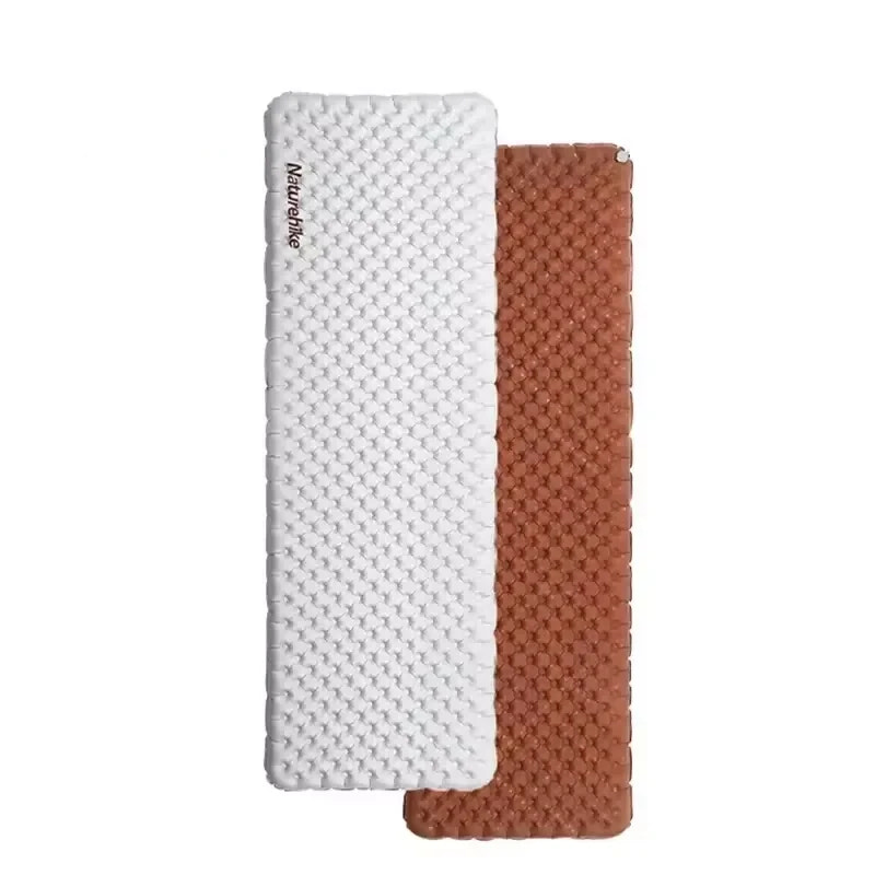 Two camping mats, one white and one brown, on a white background.
