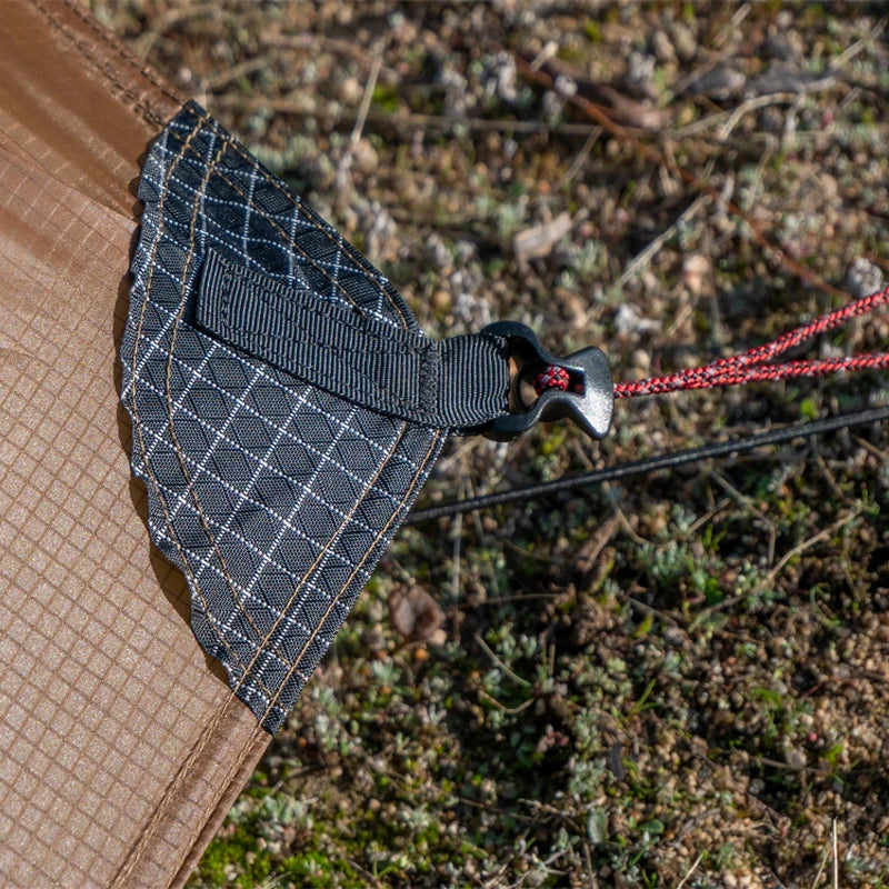 Close-up of a textured fabric with a grid pattern on a natural background
