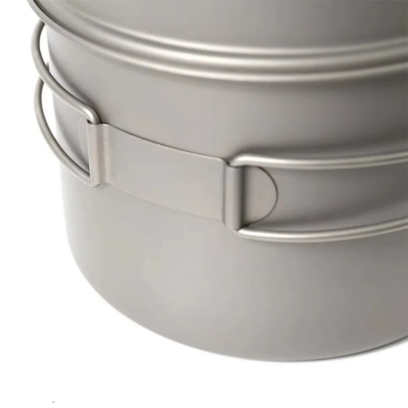 Close-up of a gray titanium pot with handles on a white background