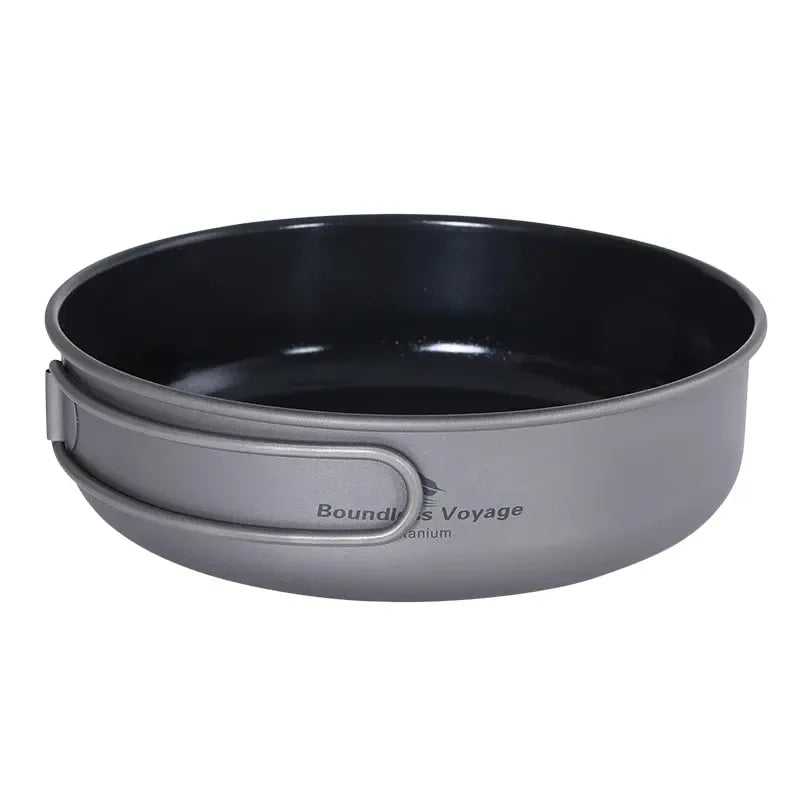 Black camping pot with gray handle on a white background