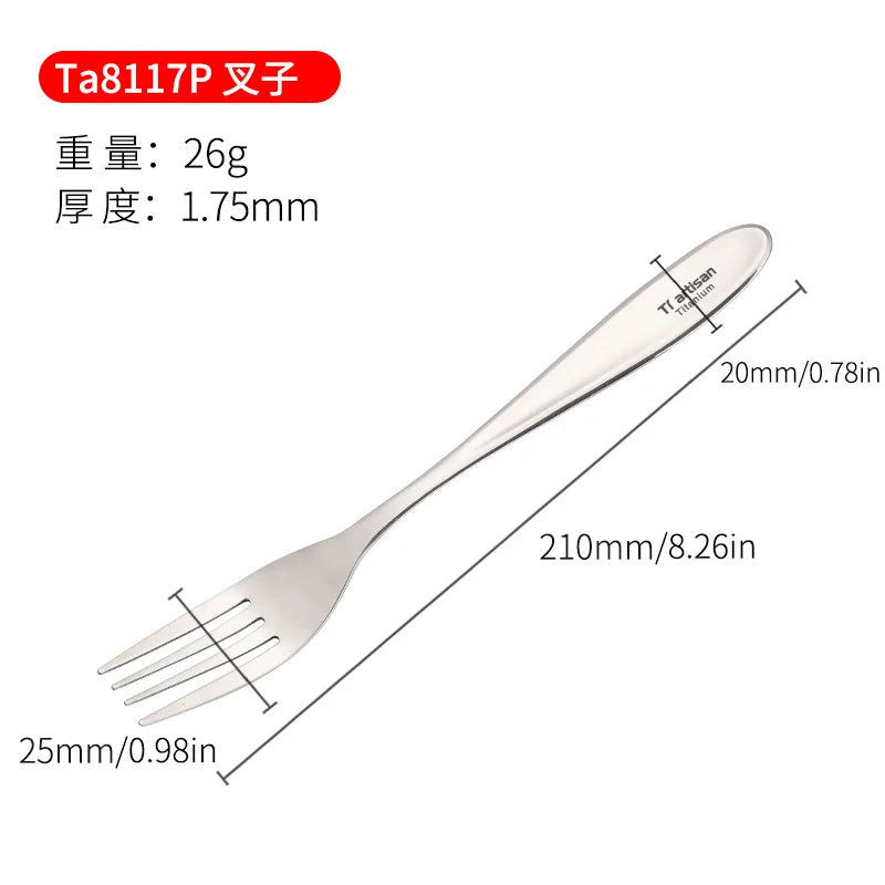 A polished titanium spoon and fork placed on a wooden board with a lemon and garlic in the background.