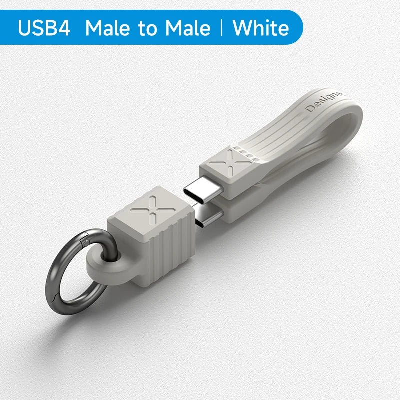White USB4 male to male adapter with keychain on a light gray background
