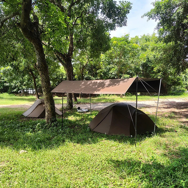 Camping scene with tents and a canopy in a forested area
