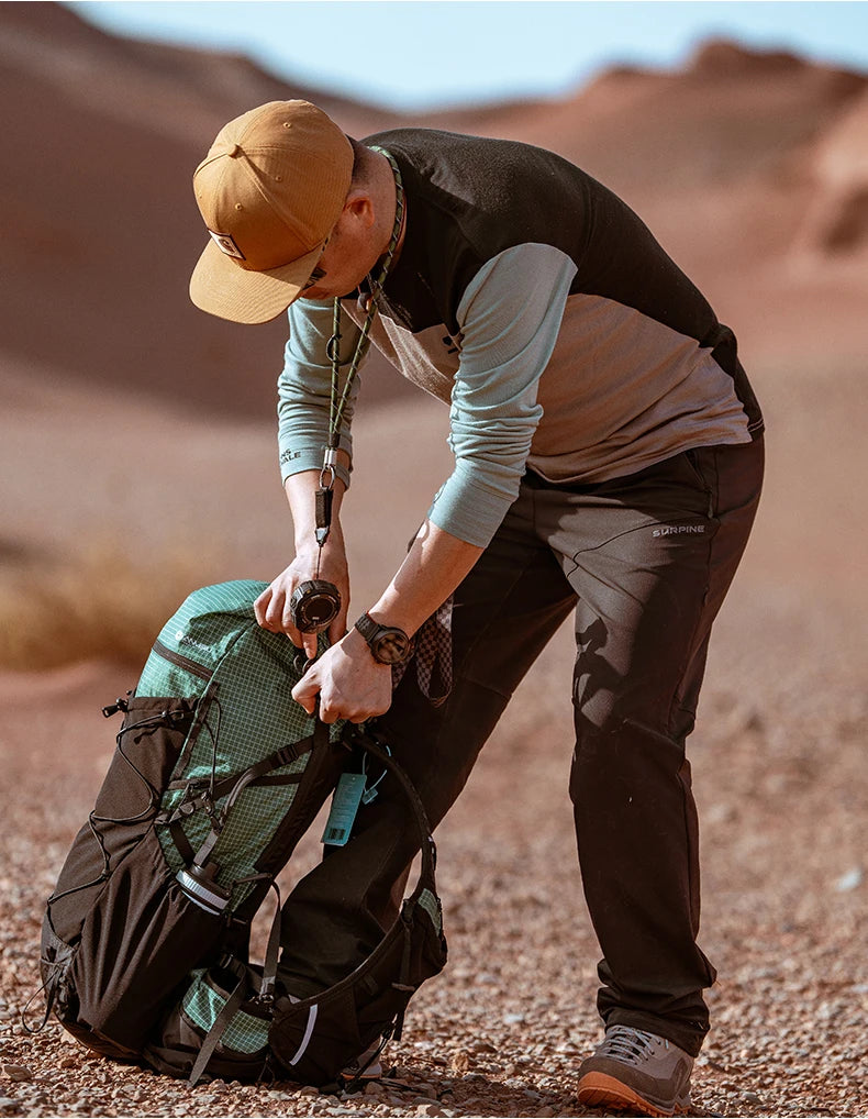 Person in desert setting preparing a backpack
