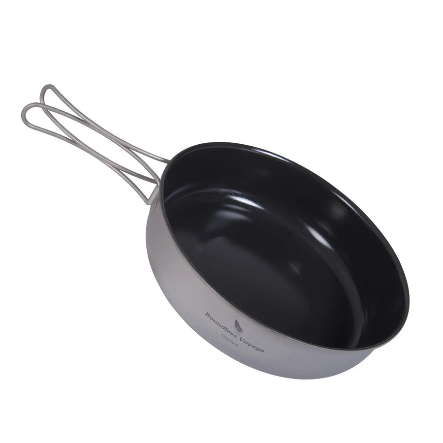 Black and gray camping pot with handle on a white background