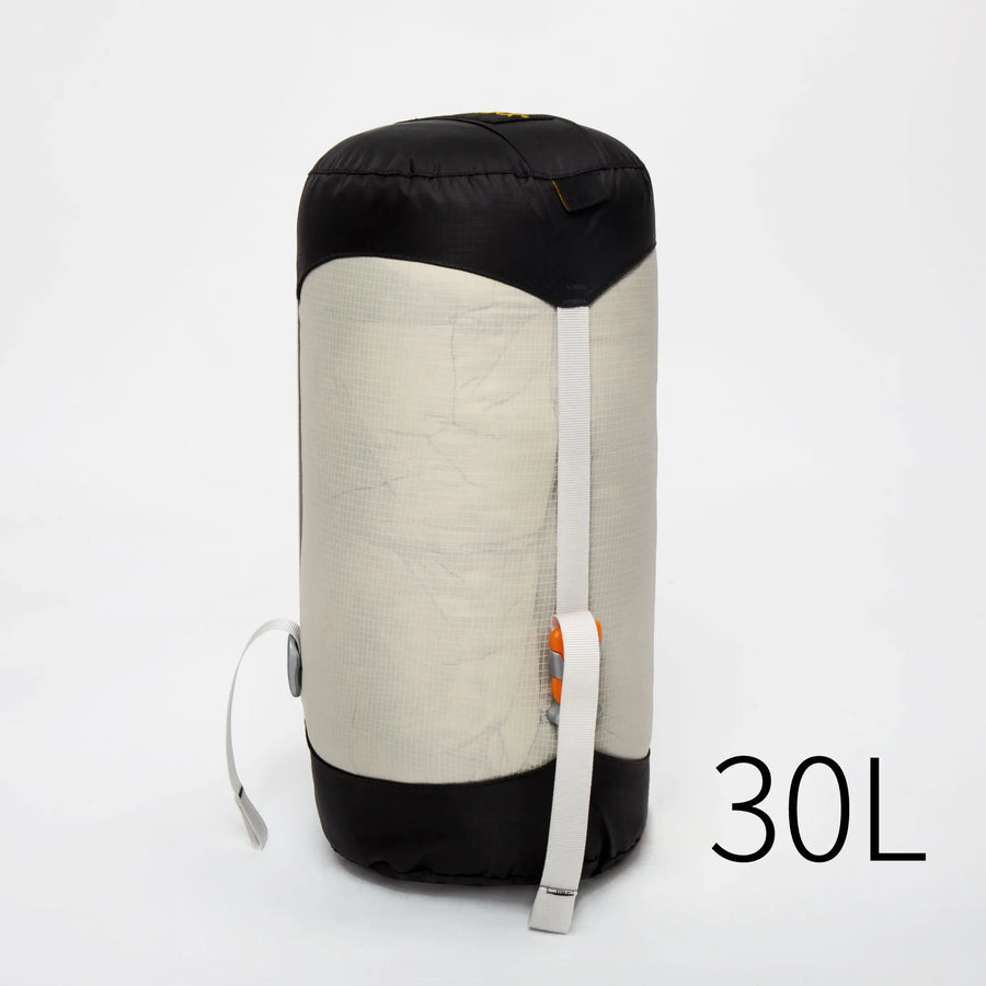 30L compression sack with black top and white body on a light gray background