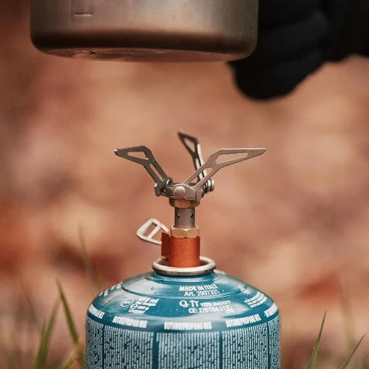pot being lifted from gas stove