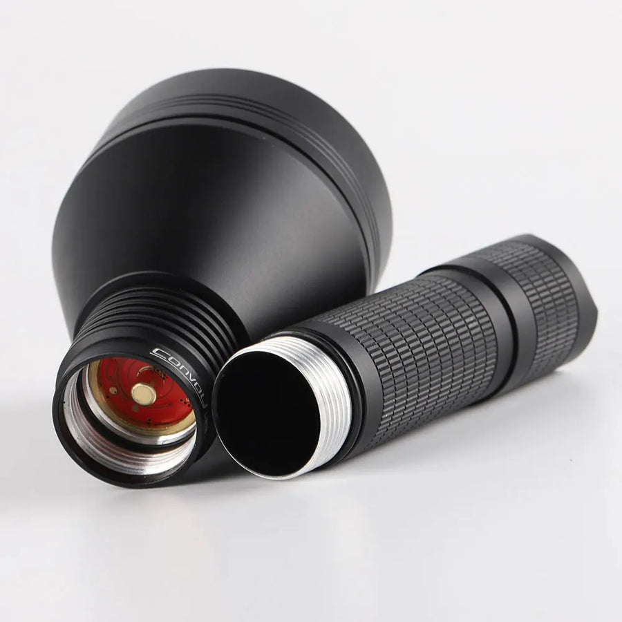 Black flashlight with textured grip on a white background