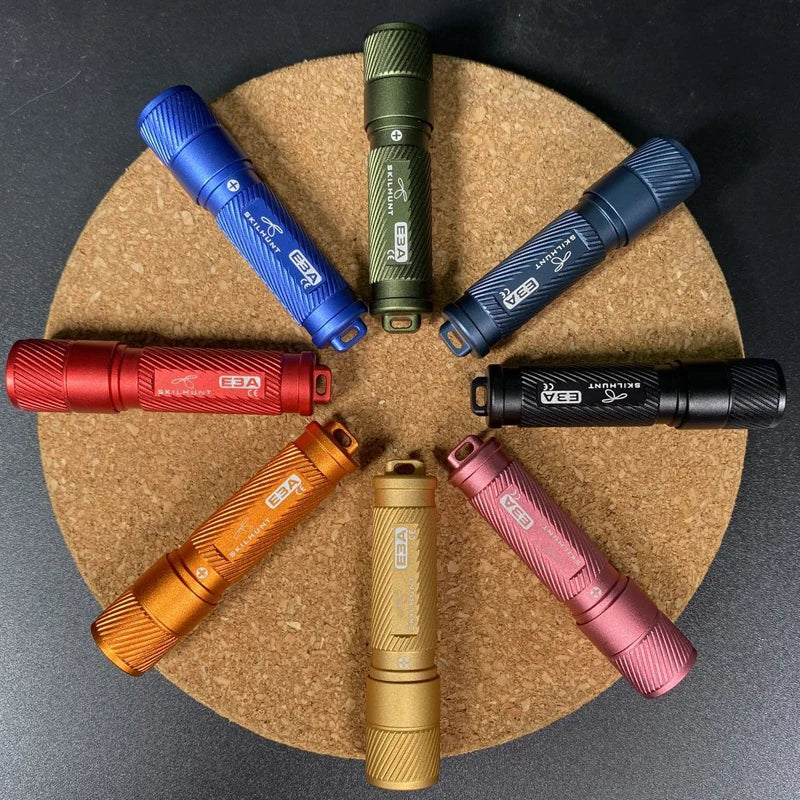 Set of colorful flashlights arranged in a circle on a cork board.