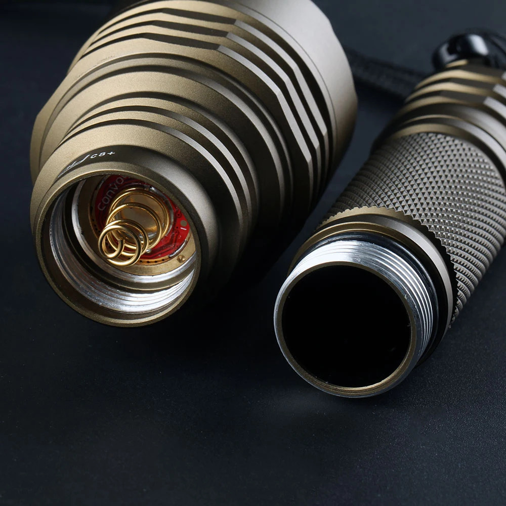 Close-up of a metallic flashlight on a dark background