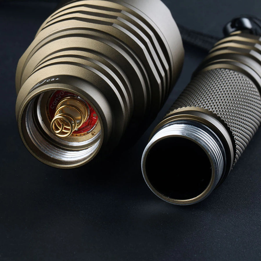 Close-up of a metallic flashlight on a dark background