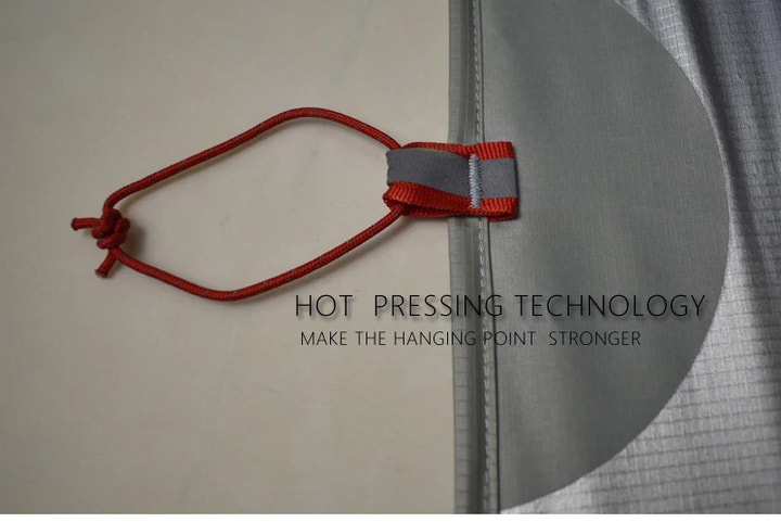 Red string with a knot tied to gray fabric, highlighting hot pressing technology.