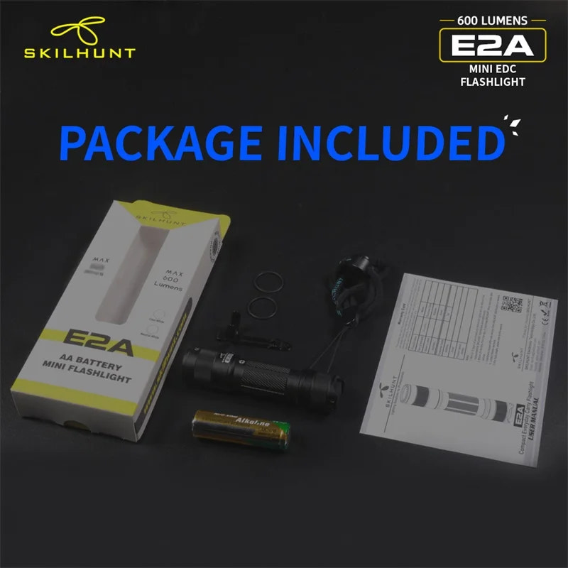 Skilhunt E2A mini flashlight package with flashlight, battery, and instructions on a dark background