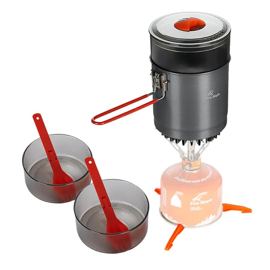 Portable camping stove with two bowls and red utensils on a white background