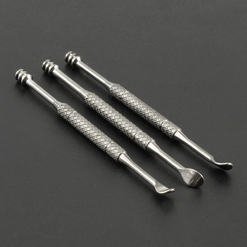 Three metallic tools with textured handles on a dark background