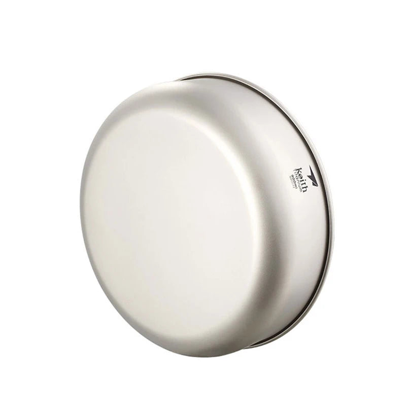 Round metallic object with a brand logo on a white background