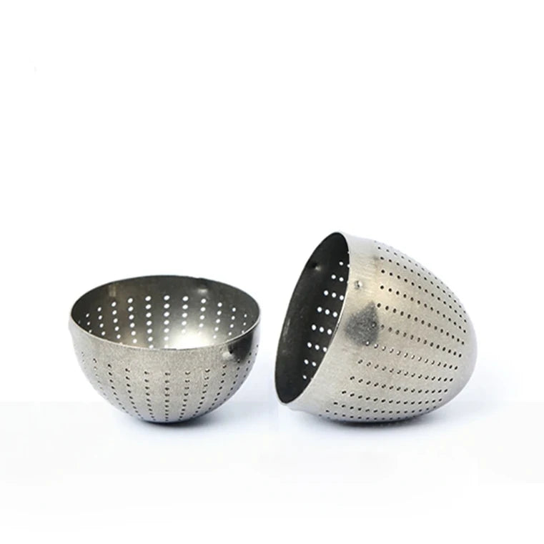 Two metal colanders with perforated designs on a white background