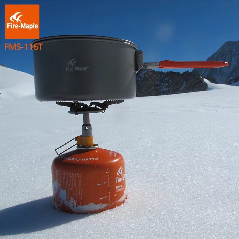 Portable cooking stove with pot and gas canister on a snowy landscape, featuring Fire-Maple branding.
