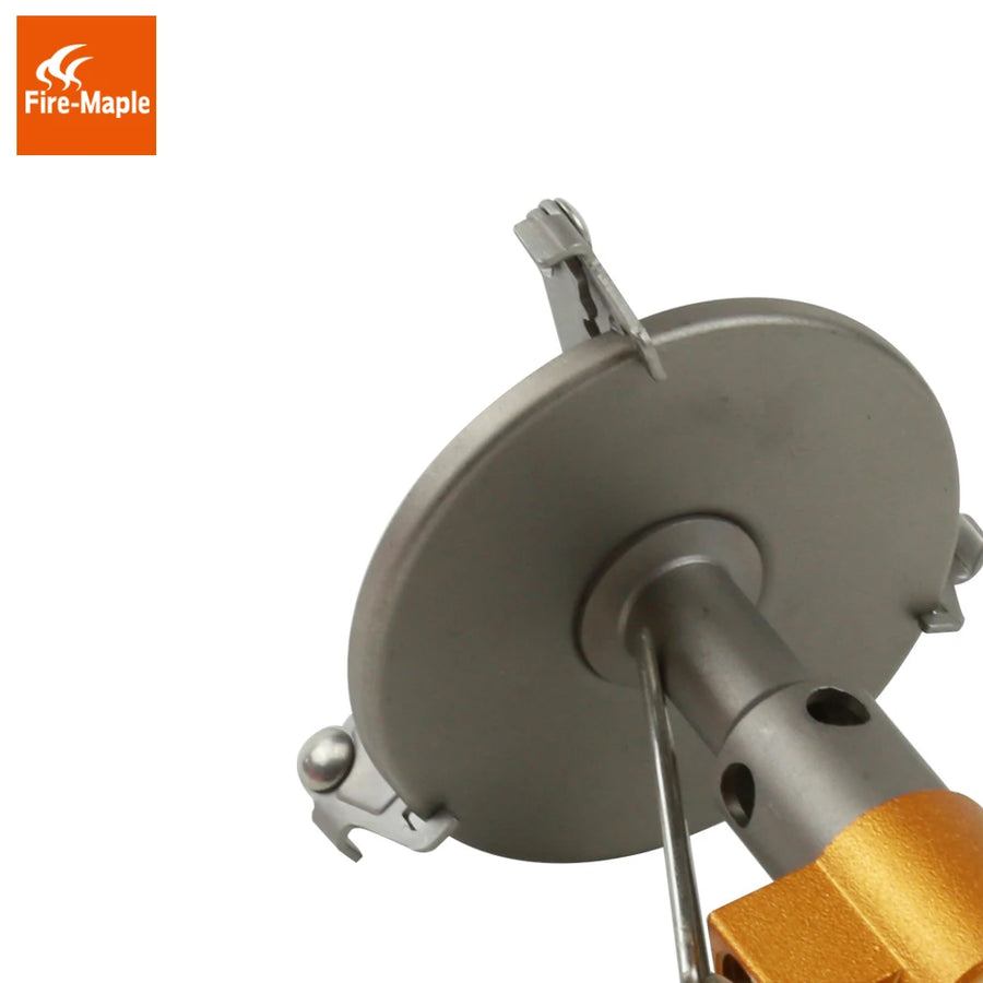 Close-up of a metal device with a gold component on a white background, featuring the Fire-Maple brand logo.
