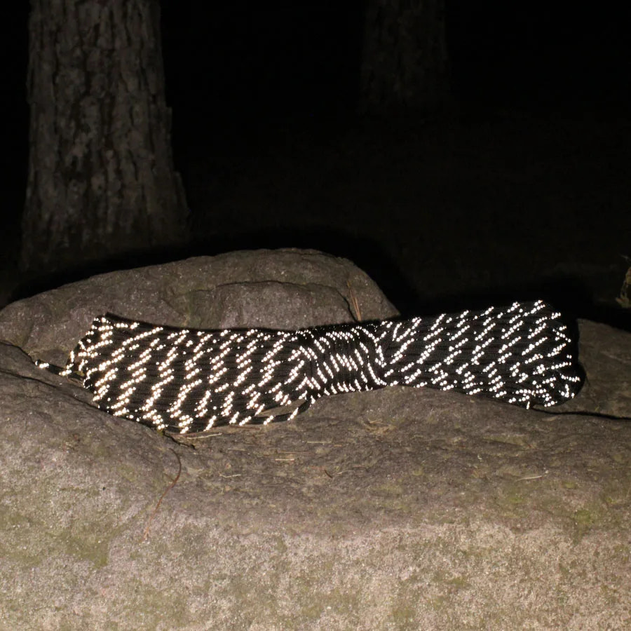 Black and white patterned rope on a stone surface at night