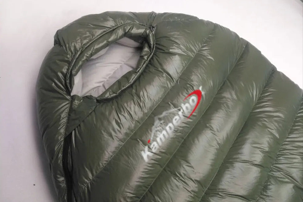 Green sleeping bag with Kamperbox logo on a white background