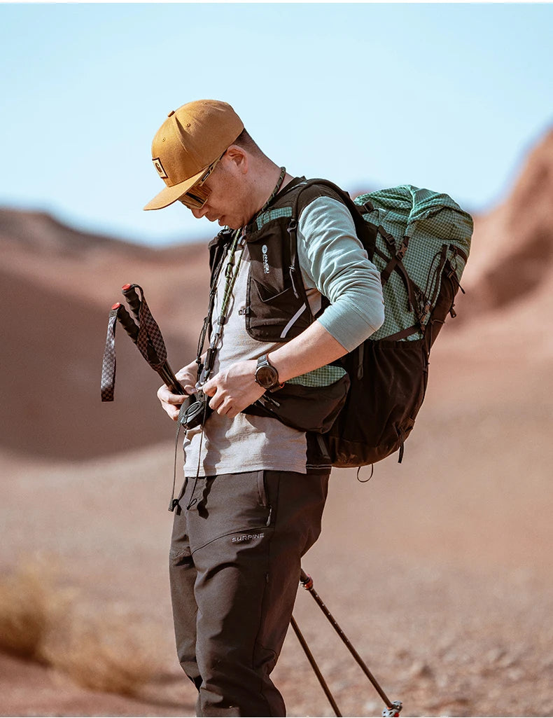 Person hiking in a desert with a backpack and walking sticks