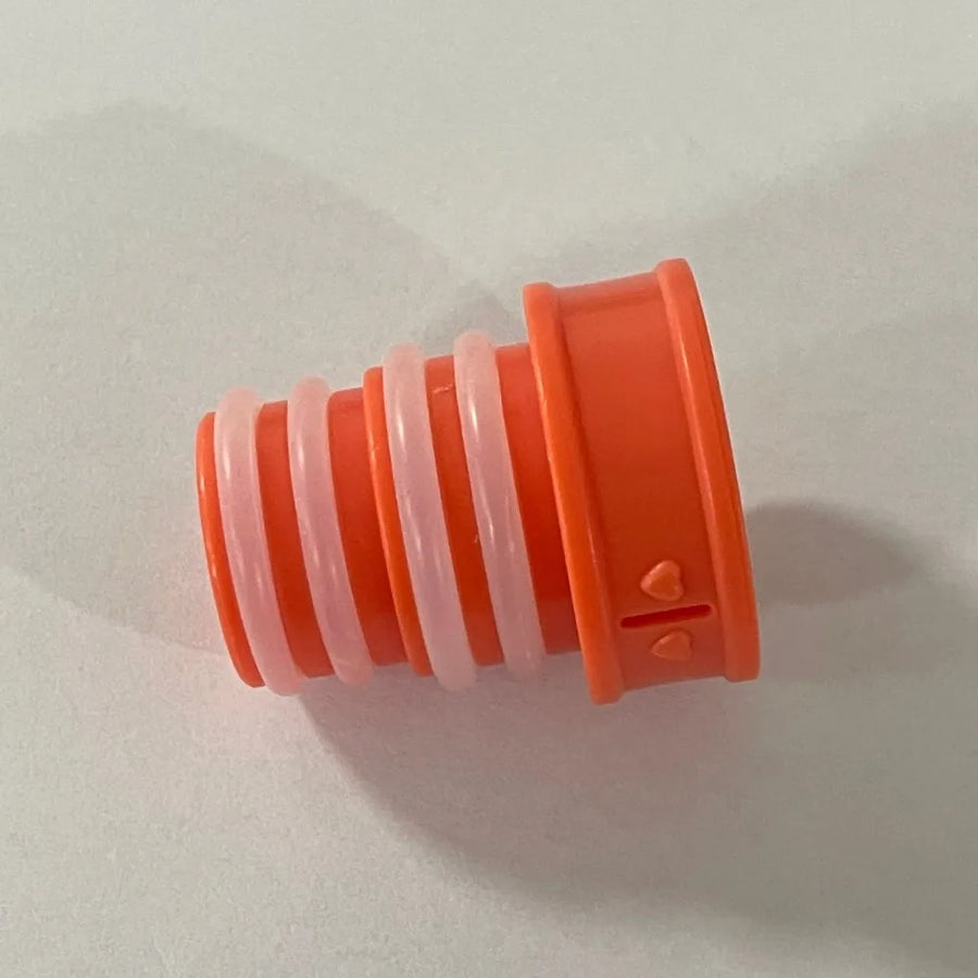 Orange plastic component with a white cylindrical part on a light gray background