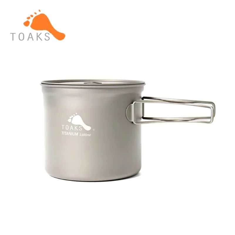 Titanium camping pot with handle on a white background, featuring the Toaks brand.