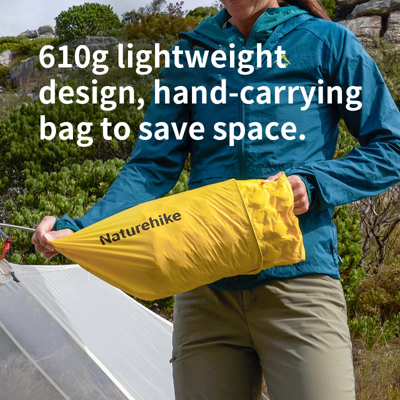 Person holding a yellow 'Naturehike' bag outdoors with text about weight and design.