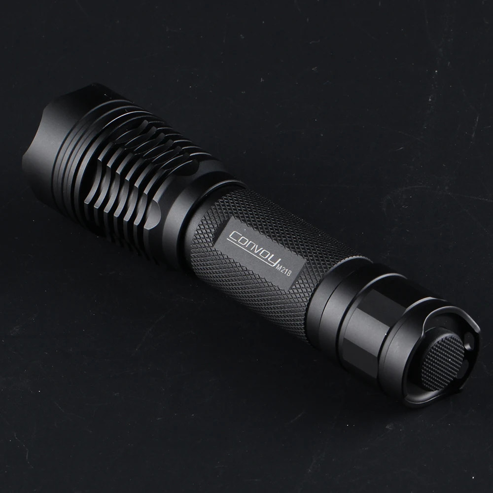 Black flashlight with 'convoy' branding on a dark background