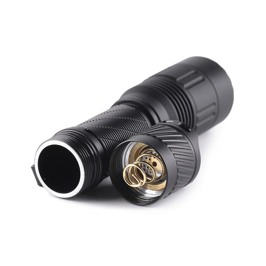 Close-up of a black metal connector with gold interior on a white background