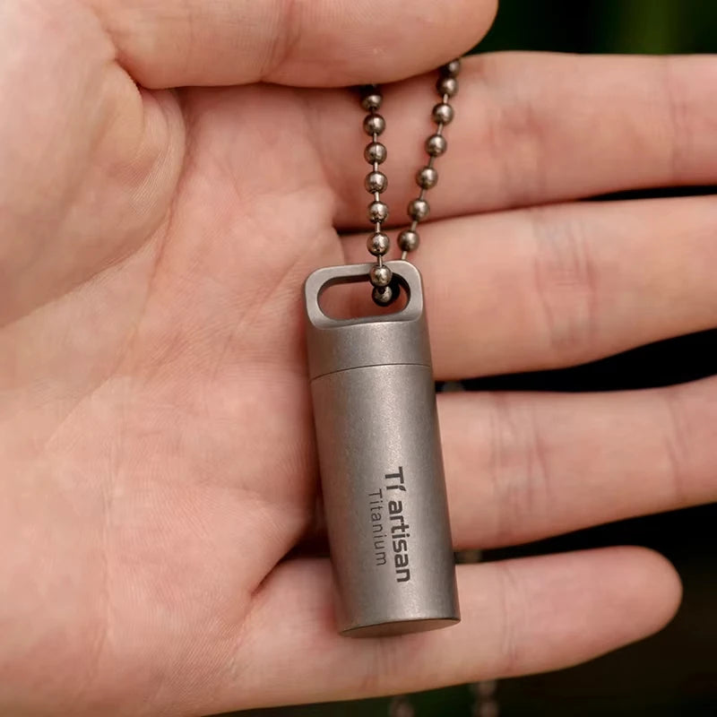 titanium bottle with chain held in a hand