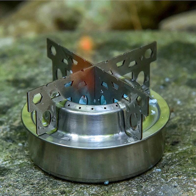 Metallic camping stove on a natural stone surface