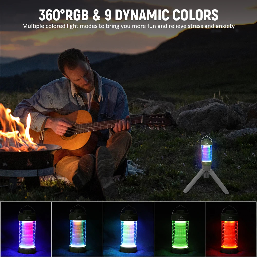 Person playing guitar by a campfire with a colorful lantern emitting light