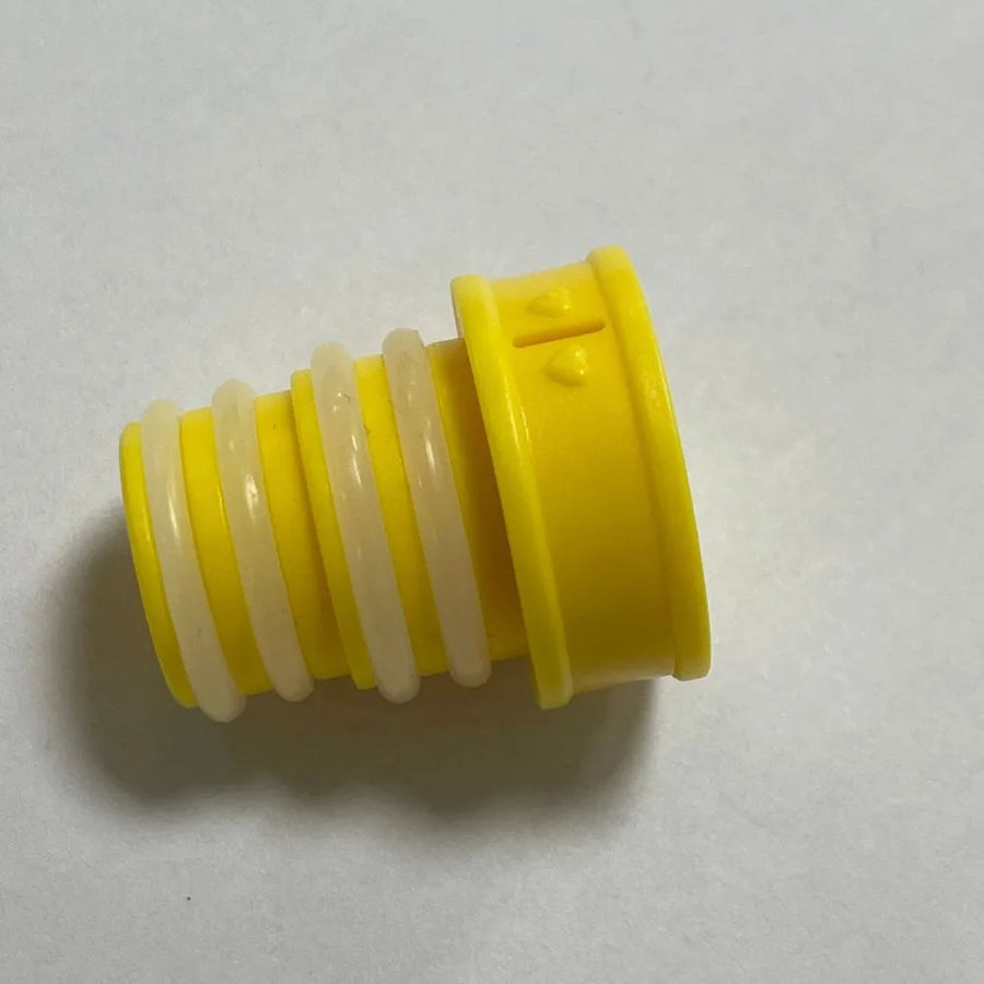 Yellow plastic cap with a white spiral inside on a light gray background