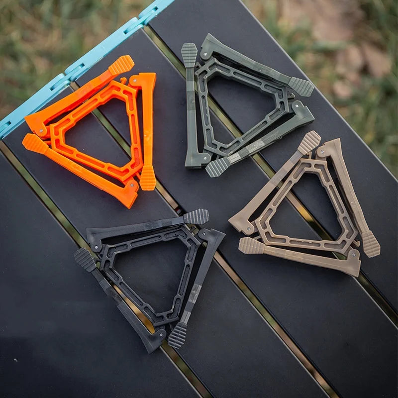 Four gas can stand holders in different colors on a black surface with a natural background.