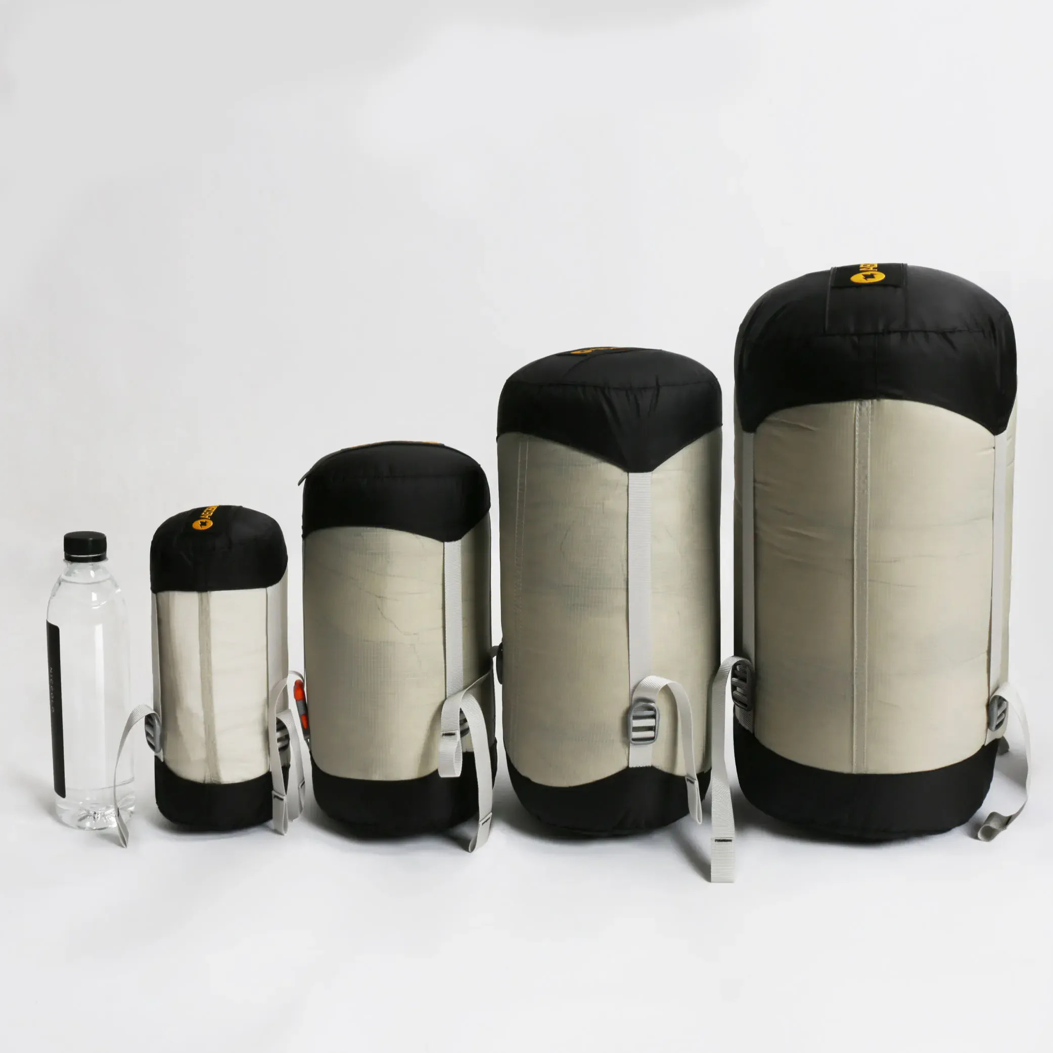 Set of four sleeping bags in different sizes on a white background