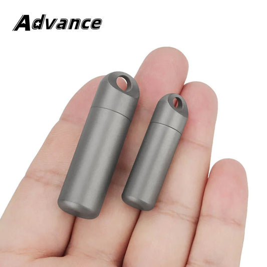 Two metallic cylindrical objects held between fingers with 'Advance' branding above.