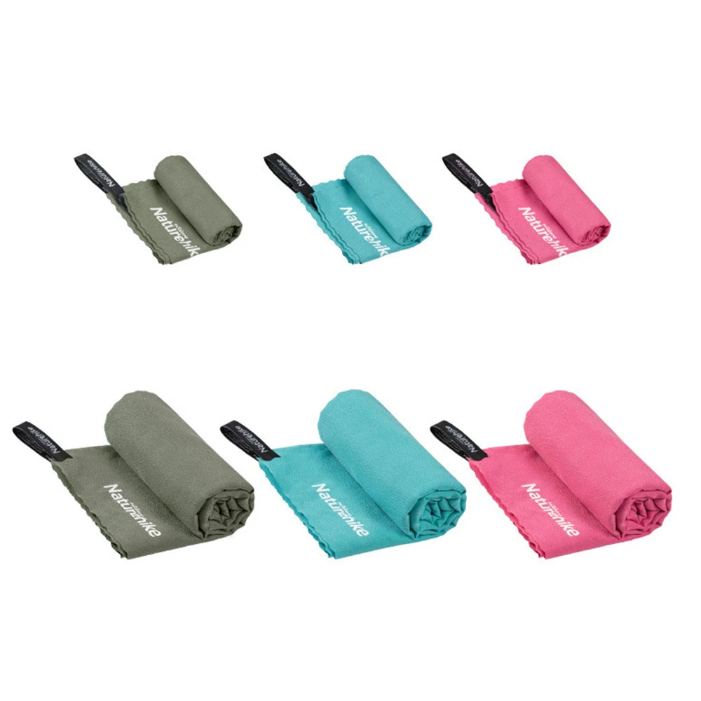 Set of rolled-up towels in green, blue, and pink with 'Naturehike' branding on a white background.