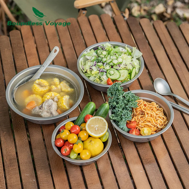 Assorted dishes including soup, salad, noodles, and vegetables on a wooden table with 'Boundless Voyage' branding.