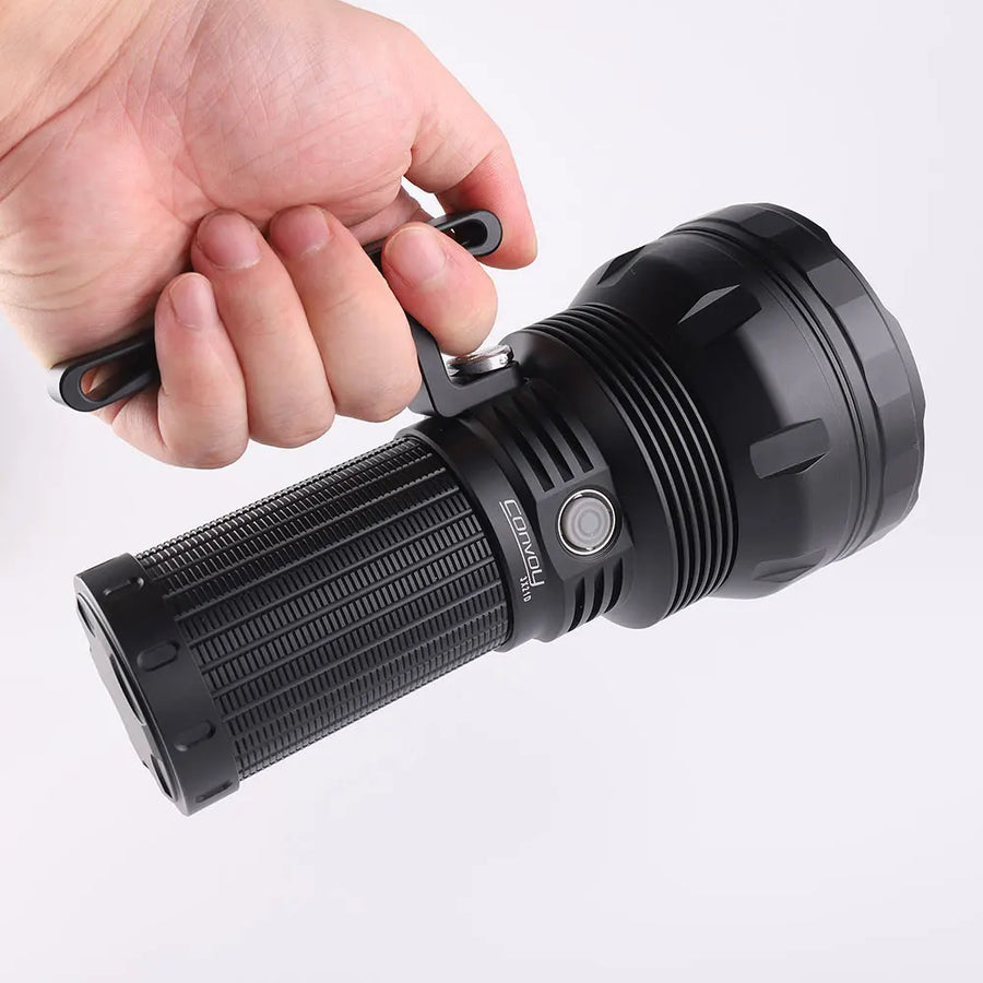 Hand holding a black flashlight against a white background